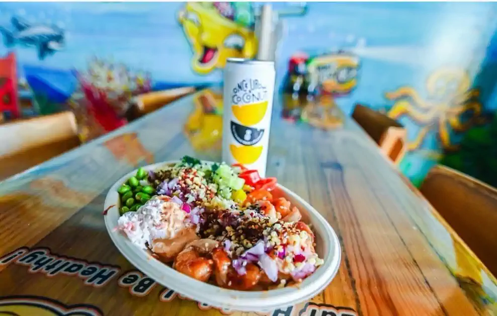 A fresh made-to-order Poke Fin bowl on the tiki bar table